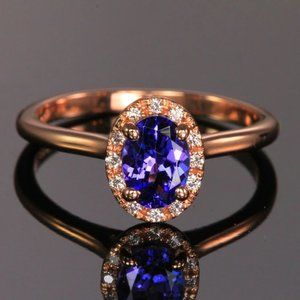 .88 CARATS OVAL TANZANITE AND DIAMOND HALO RING